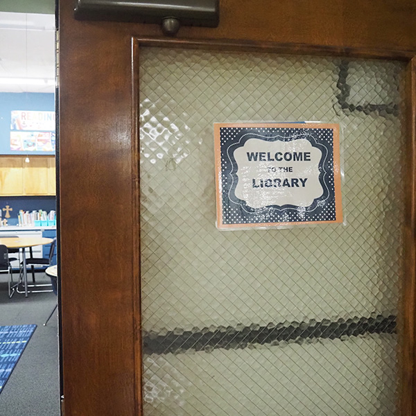 A sign on a classroom door that says "Welcome to the Library"